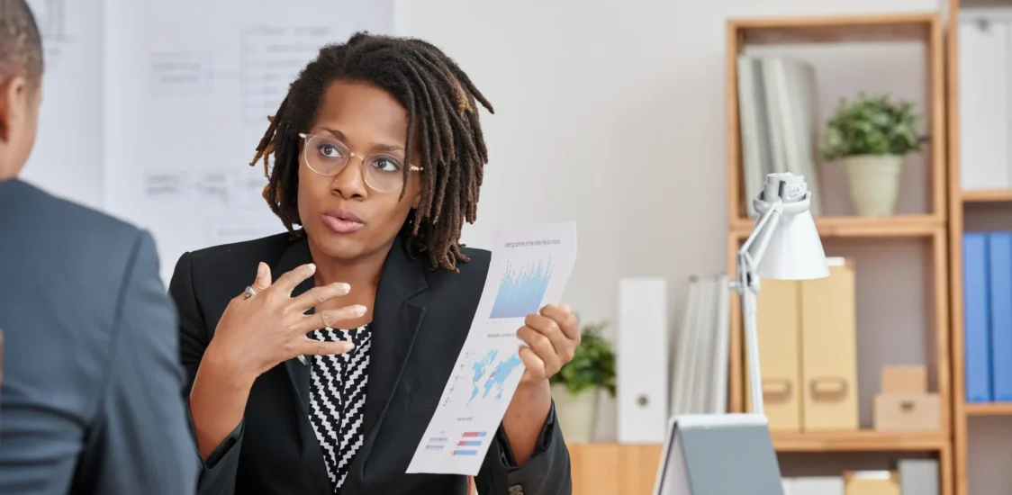 portrait-attractive-cuban-woman-presenting-statistical-information-her-unrecognizable-boss